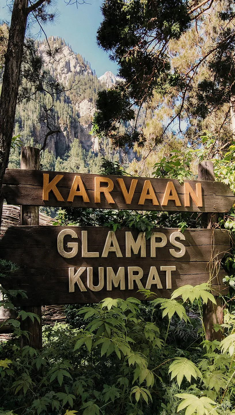 Karvaan Glamps Kumrat wooden sign in the forest